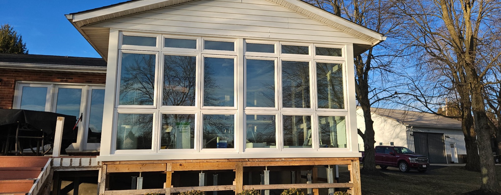 Full window wall and sunroom enclosure installed on a Mason, OH home